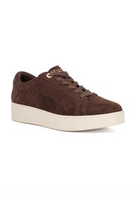 Brown suede sneaker with quilted design, featuring textured laces and a cream-colored platform sole. Gold-toned hardware detailing.