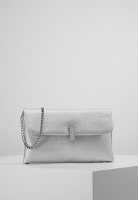 Silver clutch bag made of textured faux leather, featuring a flap closure, a metal chain strap, and a minimalistic rectangular accent.