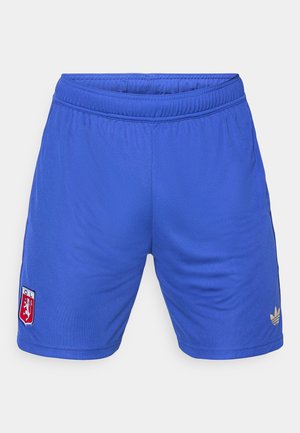 Siniset urheilushortsit, joissa on joustava vyötärö, vasemmassa reidessä pieni punainen ja valkoinen logo sekä oikeassa reidessä kultainen Adidas-logo.