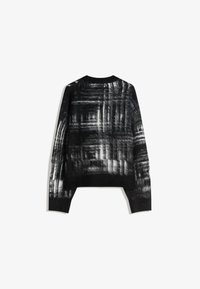 Svart tröja med ett texturerat vitt abstrakt mönster, långa ärmar, ribbade muddar och nederkant, med en rund halsringning.