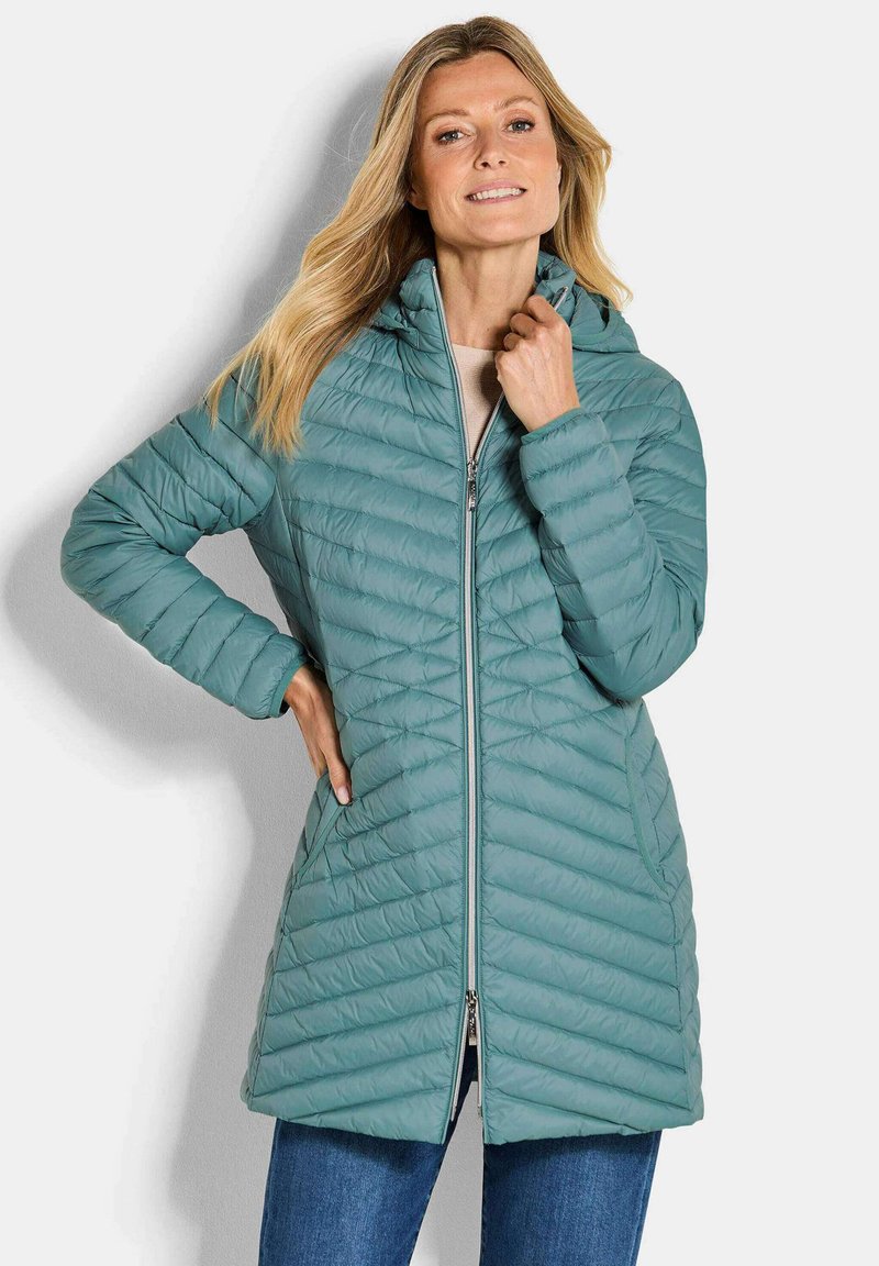 Teal pufferjack met een capuchon, voorzien van een doorstikte design, een ritssluiting aan de voorkant en twee zijzakken. Gemaakt van een lichte, gladde stof.