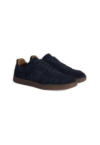 Navy blue suede sneakers with a smooth texture, featuring a brown rubber sole, lace-up design, and stitched accents on the sides.