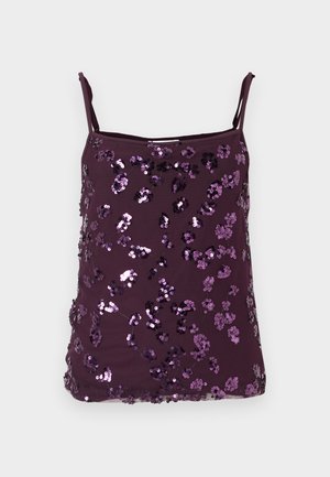 Violets kamzolis ar regulējamām lencītēm, pārklāts ar spīdīgām violetām spīdīgām pērlītēm, kas sakārtotas ziedu rakstā. Gluda auduma tekstūra.