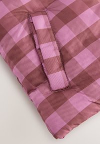 Quilted cushion with a pink and brown checkered pattern, featuring a fabric loop for handling, made of soft synthetic material.