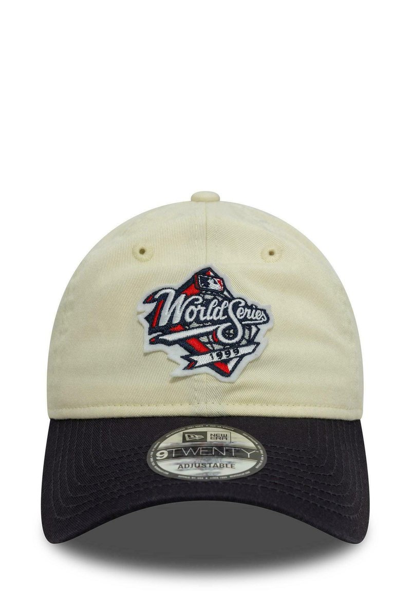 Beige cotton cap with a black bill, featuring an embroidered "World Series" logo in red, white, and blue on the front. Adjustable strap.