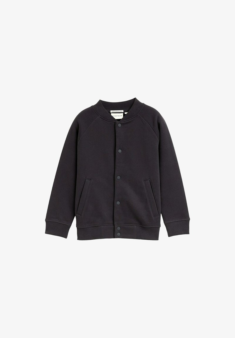 Must värviline puuvillasegu jakki ümmarguse kaelusega, nööbiga sulgemisega, raglanvarrukatega ja kahe esikotlaga. Sujuv tekstuur.