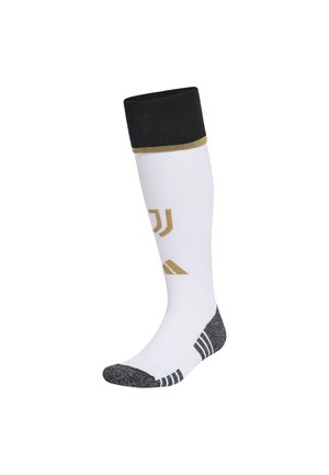 Chaussette de sport blanche montant jusqu'au genou avec bord-côte noir en haut, bout et talon gris, avec un logo doré et des rayures sur le côté.
