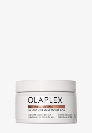 Olaplex Rich Hydration Mask i en cylindrisk vit behållare med skruvkork. Etiketter i svart och roséguld med produktinformation.