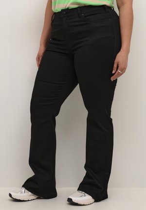 Schwarze hoch taillierte Hose in einem figurbetonten Design mit geradem Bein, aus einem glatten Material gefertigt. Mit flachen Fronttaschen und Gürtelschlaufen ausgestattet.
