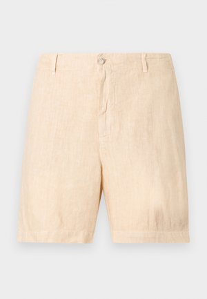 Shorts en lin beige avec un devant plat, fermeture à boutons et poches latérales. La texture est légère et légèrement froissée.