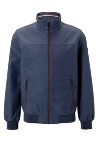 Marine blauwe zip-up jas met een hoge kraag, textuurstof, twee voorzakken met rits en contrasterende rode ritsaccenten.