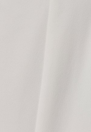 Pehmeä, teksturoitu kangas off-white-värissä, jossa on sileä pinta ja hienoinen kiilto, sisältäen hienovaraisia sävyvaihteluita ja valon heijastuksia.