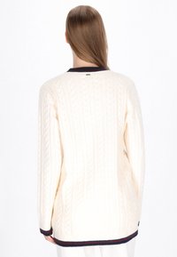Cremfarbener Kabelstrickpullover mit navyblauem Rippenkragen und -saum. Verfügt über ein strukturiertes Muster und lange Ärmel mit lässiger Passform.