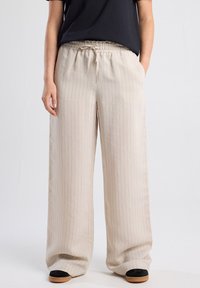 Beige wide-leg pants with vertical pinstripes, elastic waistband, and drawstring. Made of lightweight fabric, featuring a relaxed fit.