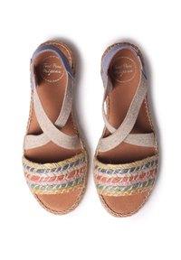 Espadrille sandals with a multi-colored woven strap, beige textile upper, and a natural jute sole. Features cross straps and a padded footbed.
