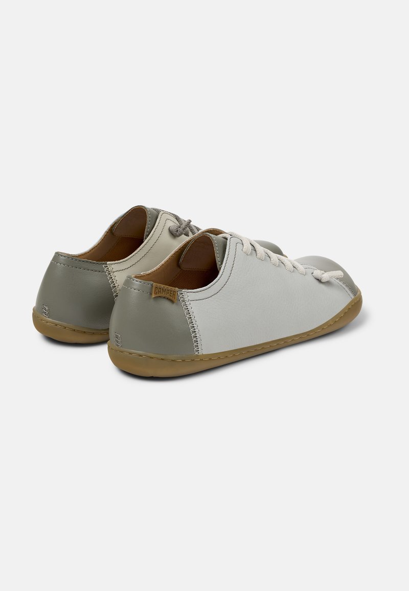 Leather shoes in grey and off-white, featuring a rounded shape, beige rubber sole, light grey laces, and a tan tag on the heel.