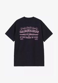 Czarna bawełniana koszulka z różowym, vintage'owym tekstem i grafiką na plecach, podkreślająca "Carhartt" oraz "Praca w toku".
