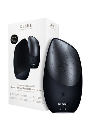 Sort GESKE 6-i-1 sonisk termisk ansigtsbørste med teksturerede og glatte sider, vist med sin hvide emballageæske