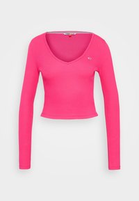 Tvarovaný top s dlouhým rukávem v jasně růžové bavlně, se závojem ve tvaru V a zkráceným lemem. Malá logo visačka na levé části hrudi.