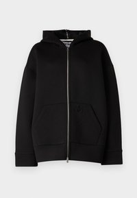 Hoodie noir zippé avec une poche kangourou, fabriqué en tissu en coton mélangé. Présente une capuche et un logo ton sur ton embossé sur la poche.
