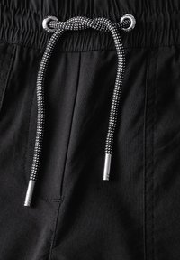 Black shorts featuring an elastic waistband with a contrasting black and white drawstring. The fabric is soft with a smooth texture.