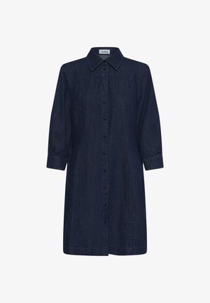 Tumesinises denimist särkkleit terava krae, nööpidega ees ja kolmeveerandvarrukatega. Iseloomustab sirge lõige ja kerge tekstuur.