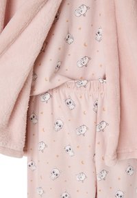 Pink fleece jacket over matching pink pajama top and pants with cat faces, stars, hearts, and crescent moon patterns.