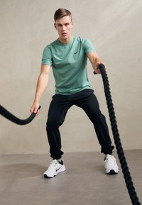 Nike Performance JOGGER - Tepláky - black/white