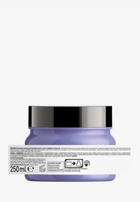 Tarro cilíndrico morado con tapa metálica negra, que presenta una etiqueta blanca con información del producto e instrucciones, tamaño de 250 ml.