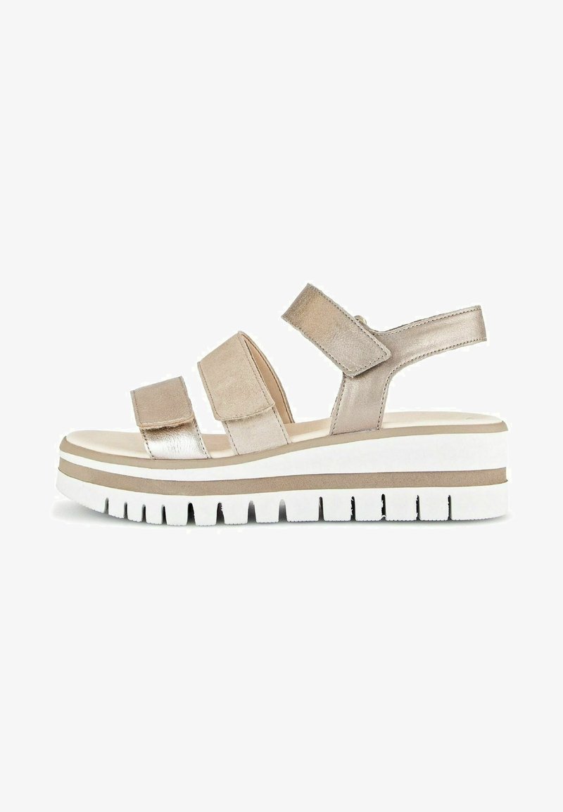 Metallic beige sandal with three straps, foam footbed, and a chunky white sole with grooves. Adjustable back strap for secure fit.