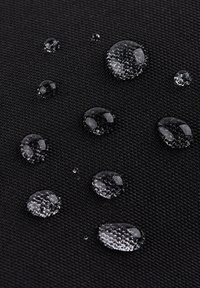 Black textured fabric with water droplets on the surface, showcasing water-resistant properties. Droplets vary in size and clarity.