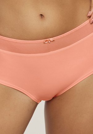 Peach-colored women's underwear with smooth fabric, a comfortable waistband, and a small bow accent at the front.