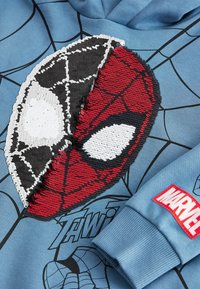 Blue hoodie featuring a textured, sequined Spider-Man mask in red, black, and white, with a black spiderweb design and a red "Marvel" tag.