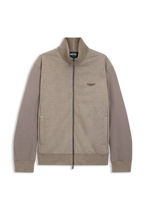 Veste beige et taupe zippée avec col montant, manches longues, poches latérales et petit logo brodé sur la poitrine gauche.