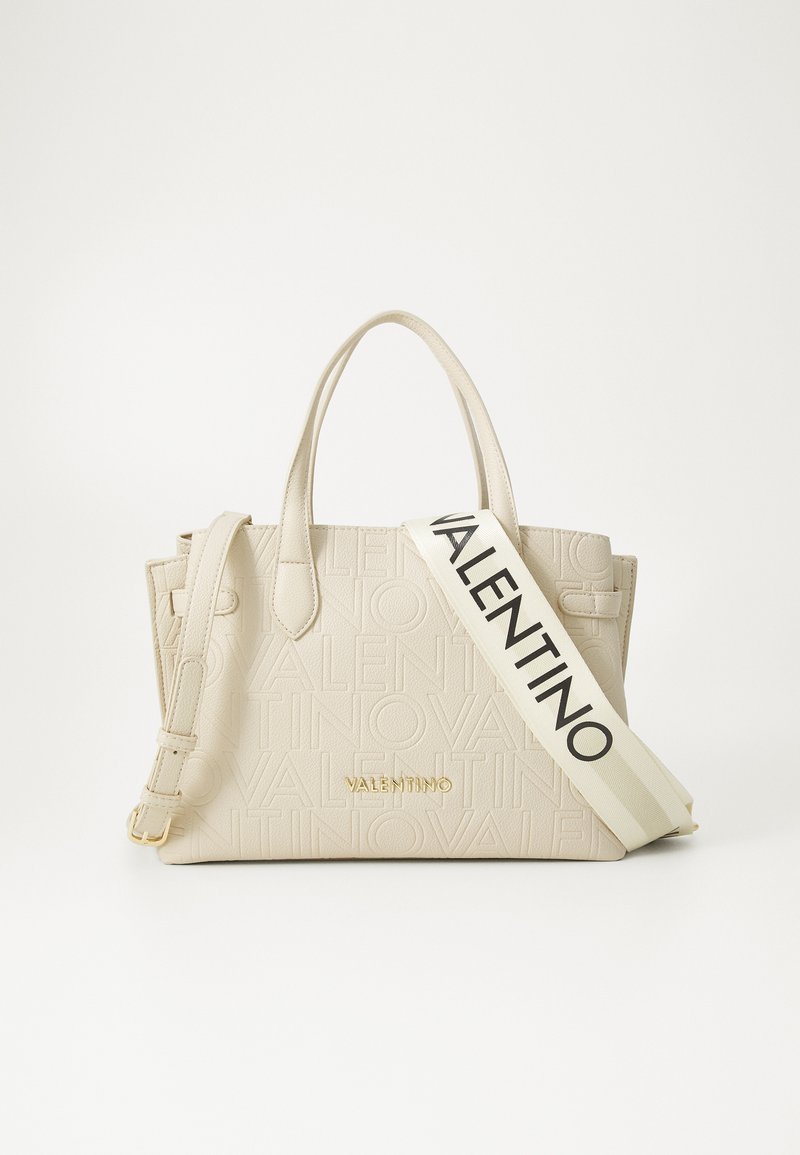 Beige tote bag with embossed "Valentino" logo, gold hardware, dual handles, and a removable strap featuring black text. Textured leather finish.