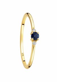 Bague en or avec un anneau lisse, présentant une pierre précieuse bleu foncé au centre et deux petites pierres blanches de chaque côté. Marquée "375" à l'intérieur.