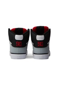 High-top sneakers featuring a black, gray, and red color scheme, with a textured upper, white sole, and prominent logo on the heel.