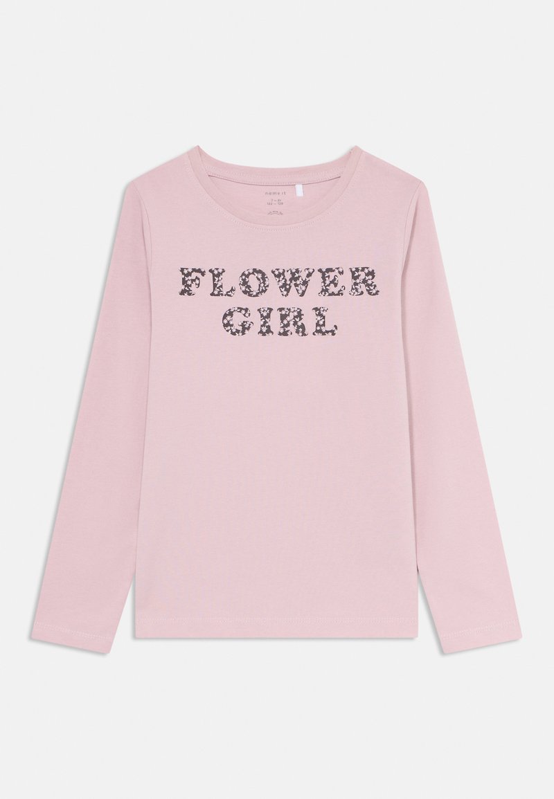 Long-sleeve pink T-shirt made of cotton featuring "FLOWER GIRL" text in dark floral pattern on the front. Soft texture, round neckline.
