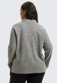 Textured gray sweater with a high collar and long sleeves, featuring a geometric pattern and relaxed fit, photographed from the back.