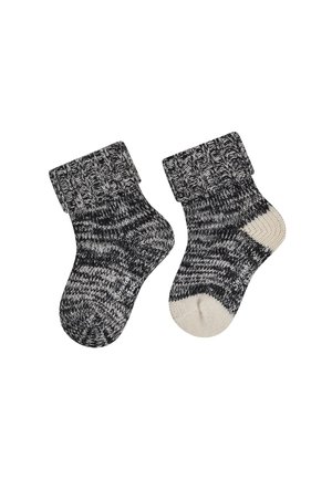 Black and white marled knit baby socks with folded cuffs, one sock showing a white heel and toe patch.