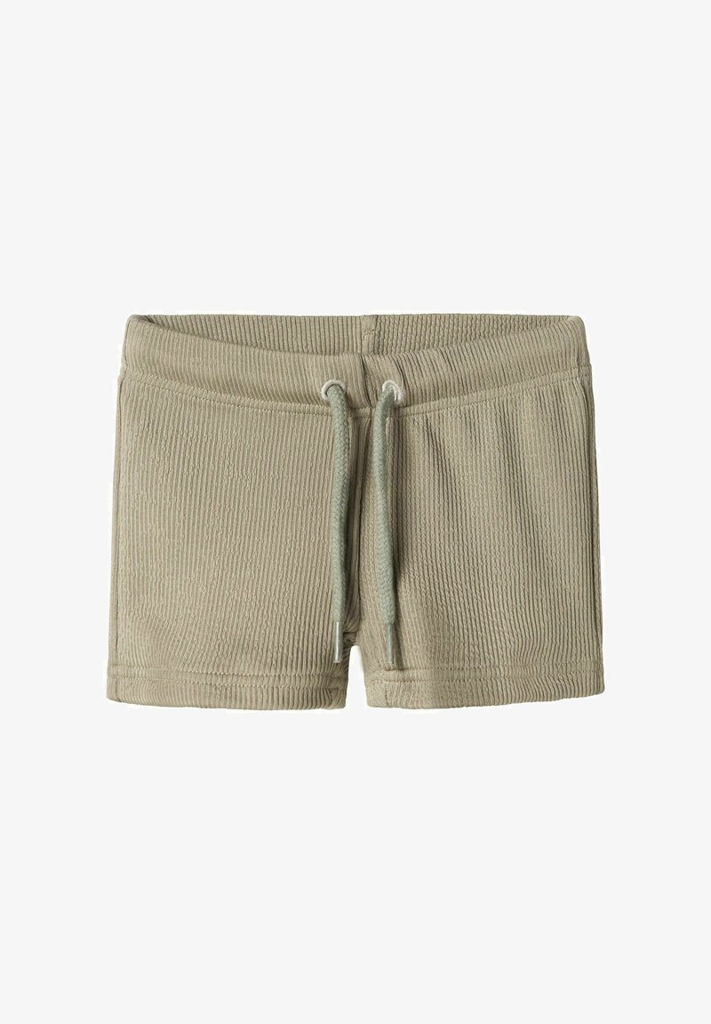 Hellgrüne, gerippte Shorts mit elastischem Bund und Kordelzug, die eine weiche Textur und ein minimalistisches Design aufweisen.
