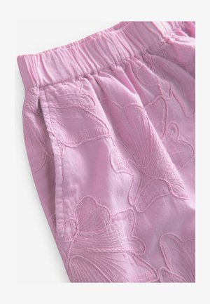 Pantaloni corti rosa ricamati con vita elastica arricciata. Presentano motivi floreali in una texture in rilievo, realizzati in un tessuto leggero.