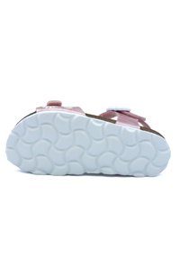 Sandale rose avec des sangles ajustables, détail floral, semelle en caoutchouc texturée et semelle extérieure lisse blanche avec un motif ondulé.