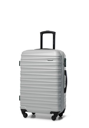 Silver hard-shell suitcase with textured horizontal grooves, retractable black handle, green accent, and four black wheels for mobility.
