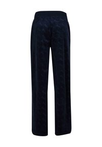 Navy blue sweatpants with a soft texture, featuring a subtle all-over logo pattern, elastic waistband, and wide-leg design.