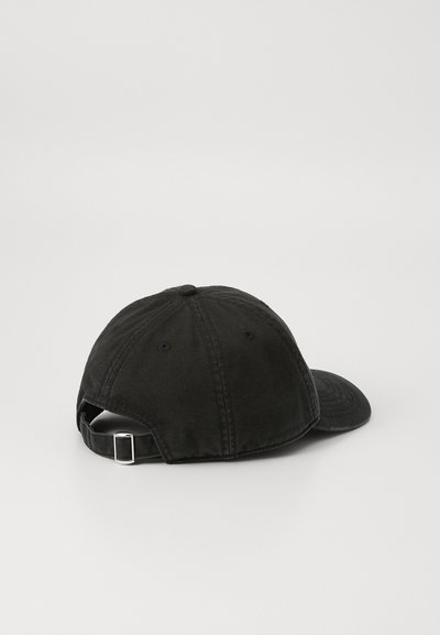 Black cotton baseball cap with a curved brim, adjustable strap at the back, and ventilation eyelets on the sides. Soft texture, unstructured design.