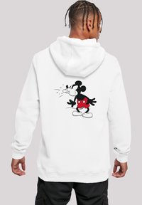 Hvit hettegenser med hette, med et stort svart og rødt trykk av Mickey Mouse på ryggen, med en løs passform og ribbestrikkede mansjetter.