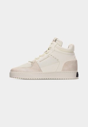 High-top beige sneaker with suede accents, lace-up front, padded collar, and textured sole, shown in side profile on white background.
