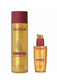 Gold shampoo bottle and smaller oil elixir, both with maroon caps. Labels in contrasting colors, featuring decorative designs and product names.