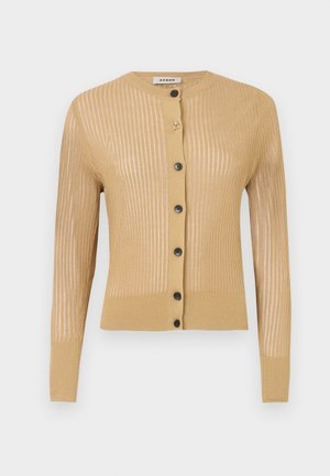 Knit cardigan in light tan, featuring vertical stripes, long sleeves, round neckline, and five black buttons down the front.